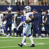 Sep 14, 2025; Arlington, Texas, USA; Dallas Cowboys safety Donovan Wilson (6) reacts after making an interception against the New York Giants during overtime at AT&T Stadium.