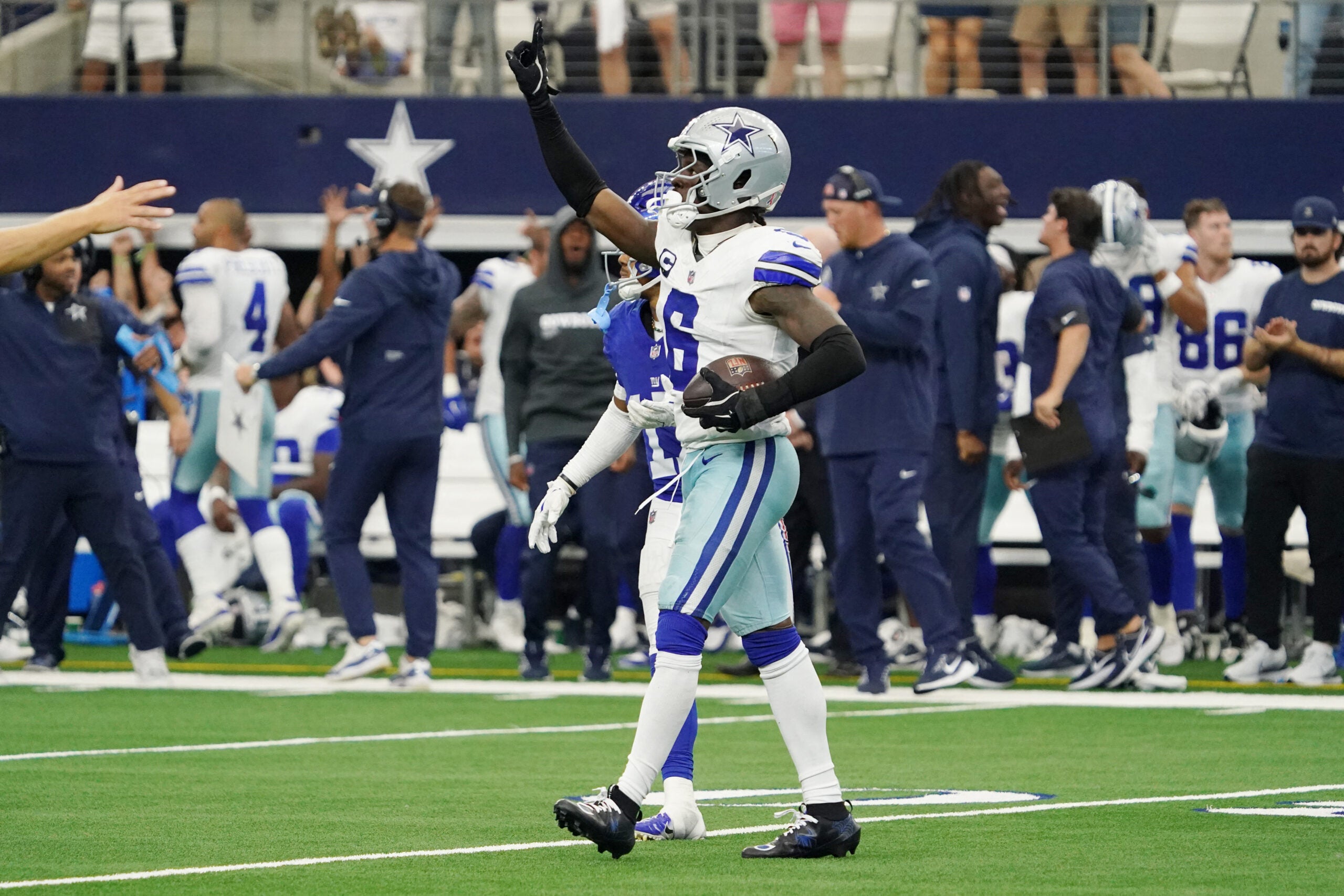 Sep 14, 2025; Arlington, Texas, USA; Dallas Cowboys safety Donovan Wilson (6) reacts after making an interception against the New York Giants during overtime at AT&T Stadium.