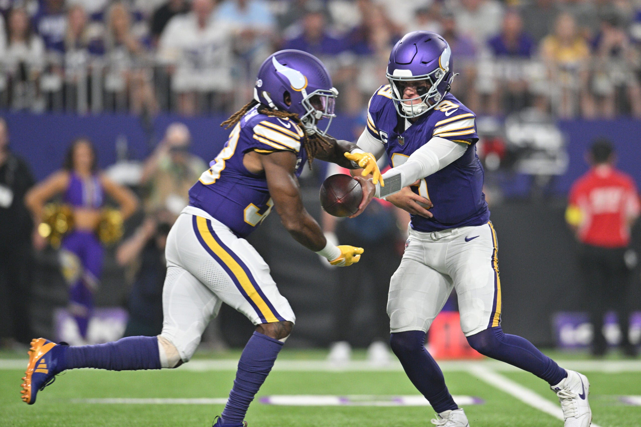 Sep 14, 2025; Minneapolis, Minnesota, USA; Minnesota Vikings quarterback J.J. McCarthy (9) hands off the ball to Minnesota Vikings running back Aaron Jones Sr. (33) during the first half at U.S. Bank Stadium.