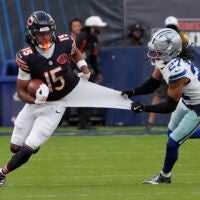 Sep 21, 2025; Chicago, Illinois, USA; Dallas Cowboys defensive back Reddy Steward (27) grabs Chicago Bears wide receiver Rome Odunze (15) jersey during the second half at Soldier Field.
