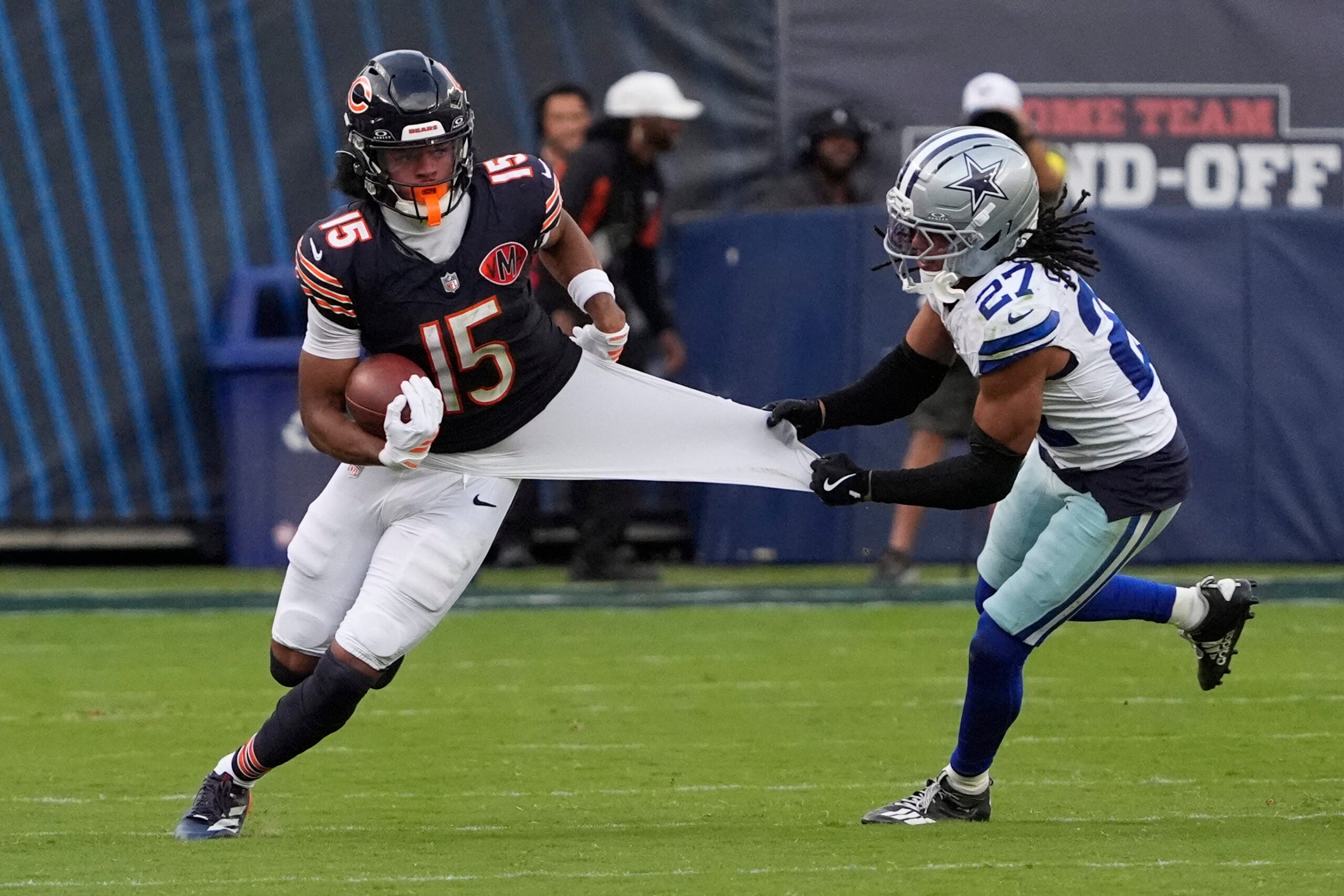 Sep 21, 2025; Chicago, Illinois, USA; Dallas Cowboys defensive back Reddy Steward (27) grabs Chicago Bears wide receiver Rome Odunze (15) jersey during the second half at Soldier Field.