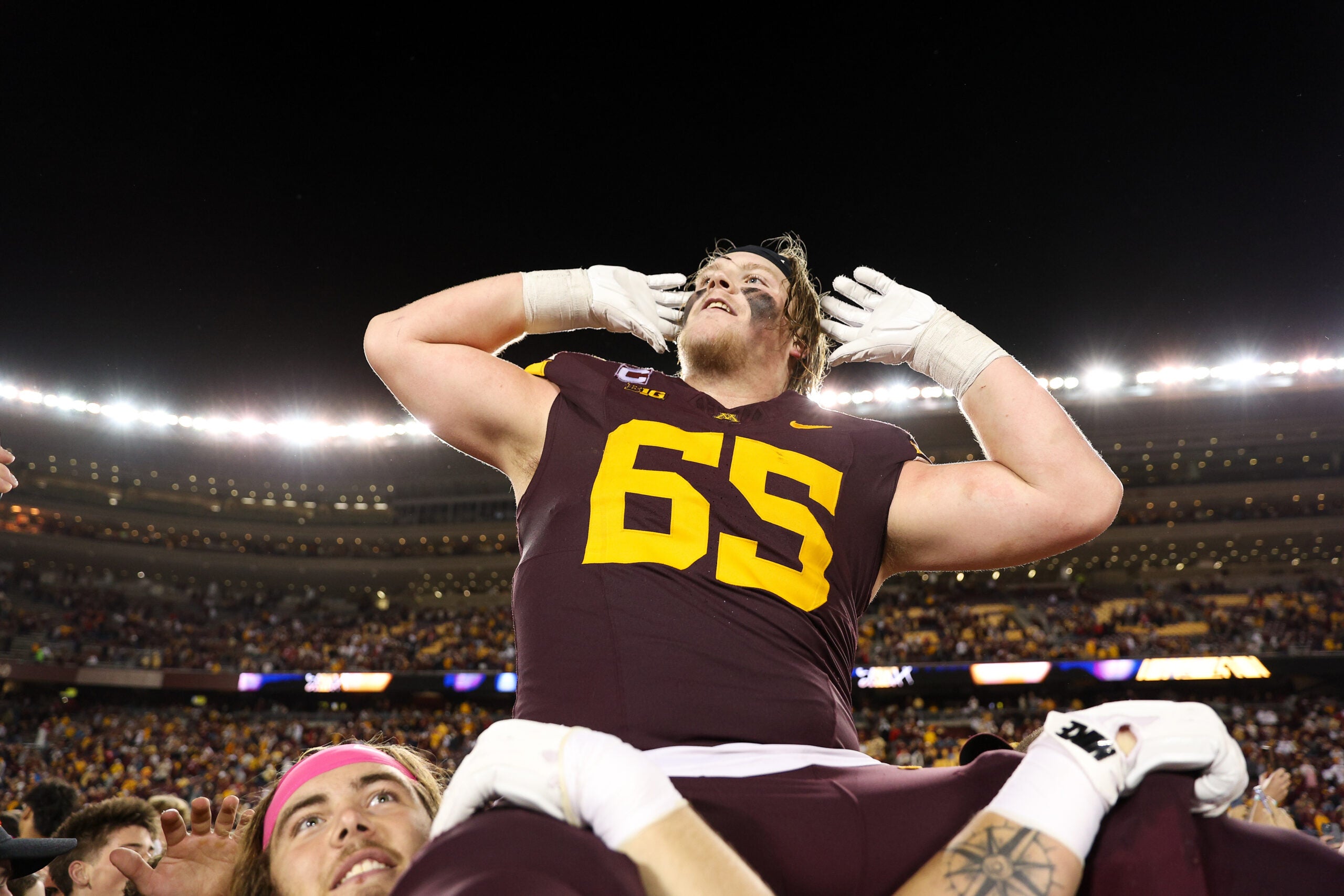 Oct 17, 2025; Minneapolis, Minnesota, USA; Minnesota Golden Gophers offensive lineman Greg Johnson (65) celebrates after the teams win against the Nebraska Cornhuskers at Huntington Bank Stadium.