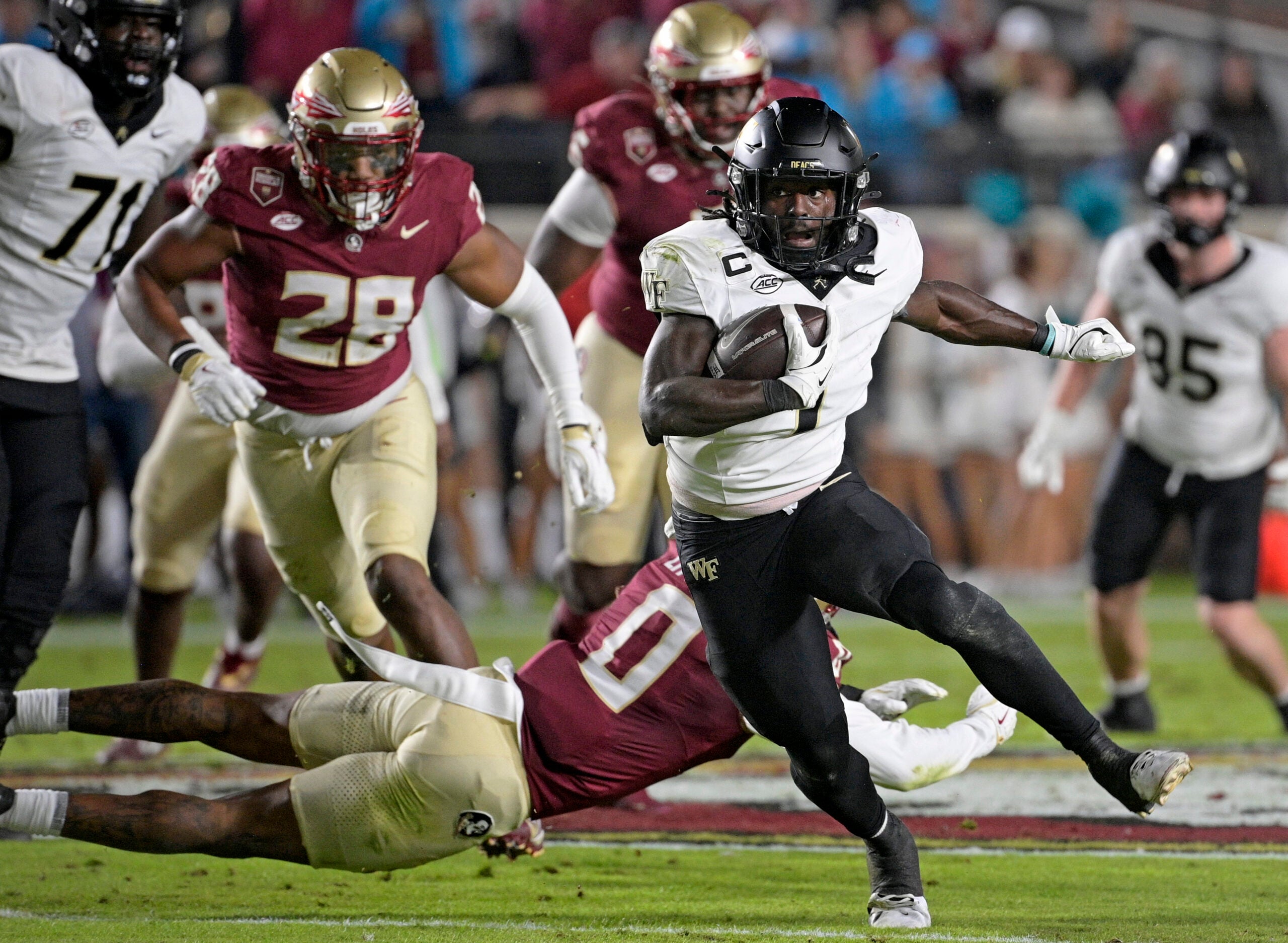Nov 1, 2025; Tallahassee, Florida, USA; Wake Forest Demon Deacons running back Demond Claiborne (1) runs the ball during the first quarter against the Florida State Seminoles at Doak S. Campbell Stadium.