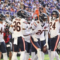 Nov 16, 2025; Minneapolis, Minnesota, USA; Chicago Bears cornerback Nahshon Wright (26) celebrates an interception with teammates during the second quarter against the Minnesota Vikings at U.S. Bank Stadium.