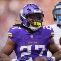 Nov 16, 2025; Minneapolis, Minnesota, USA; Minnesota Vikings running back Jordan Mason (27) runs in for a touchdown during the fourth quarter against the Chicago Bears at U.S. Bank Stadium.