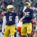 Nov 22, 2025; South Bend, Indiana, USA; Notre Dame Fighting Irish defensive lineman Bryce Young (95) celebrates a stop along side defensive lineman Boubacar Traore (5) against the Syracuse Orange during the first half at Notre Dame Stadium.
