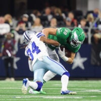 Nov 23, 2025; Arlington, Texas, USA; Philadelphia Eagles tight end Dallas Goedert (88) is brought down by Dallas Cowboys cornerback Shavon Revel Jr. (34) in the third quarter at AT&T Stadium.