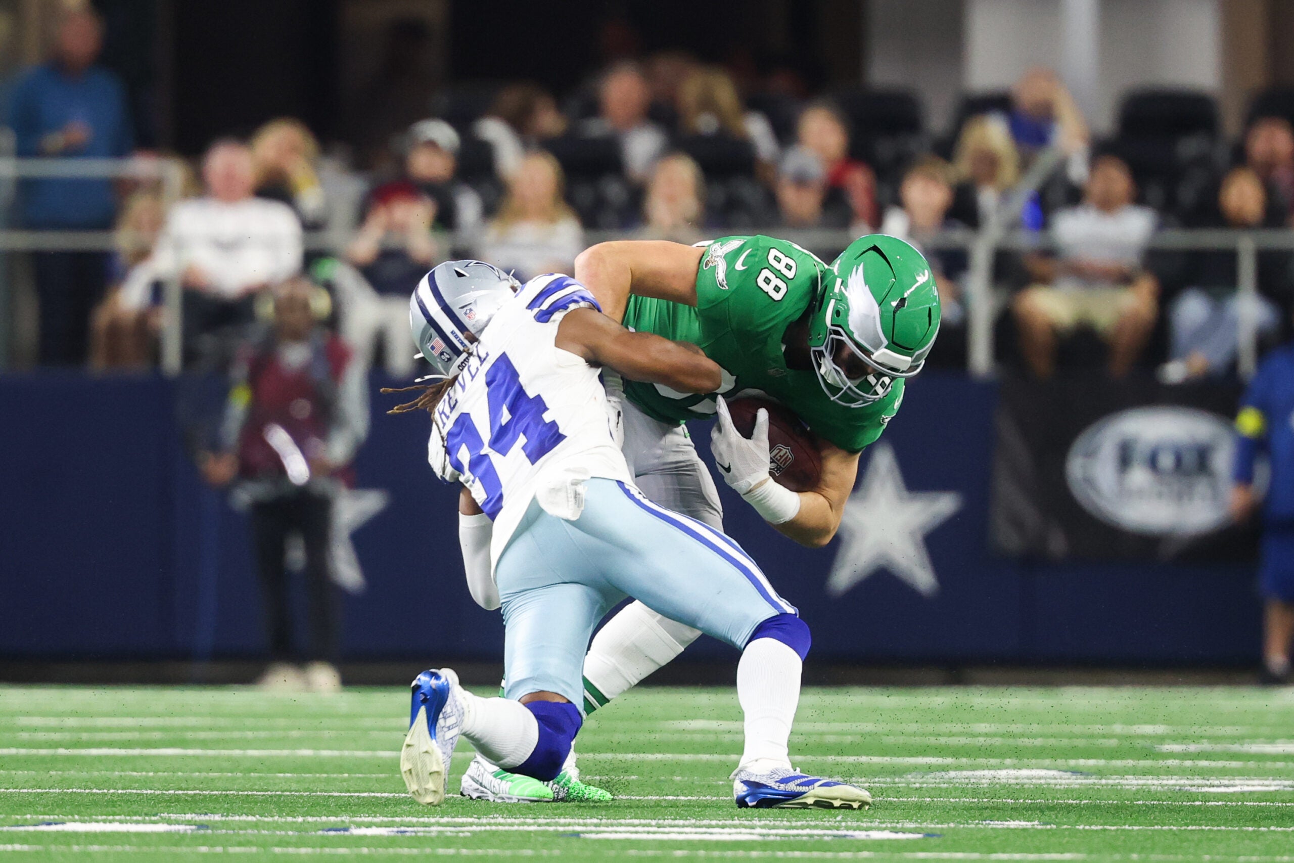 Nov 23, 2025; Arlington, Texas, USA; Philadelphia Eagles tight end Dallas Goedert (88) is brought down by Dallas Cowboys cornerback Shavon Revel Jr. (34) in the third quarter at AT&T Stadium.