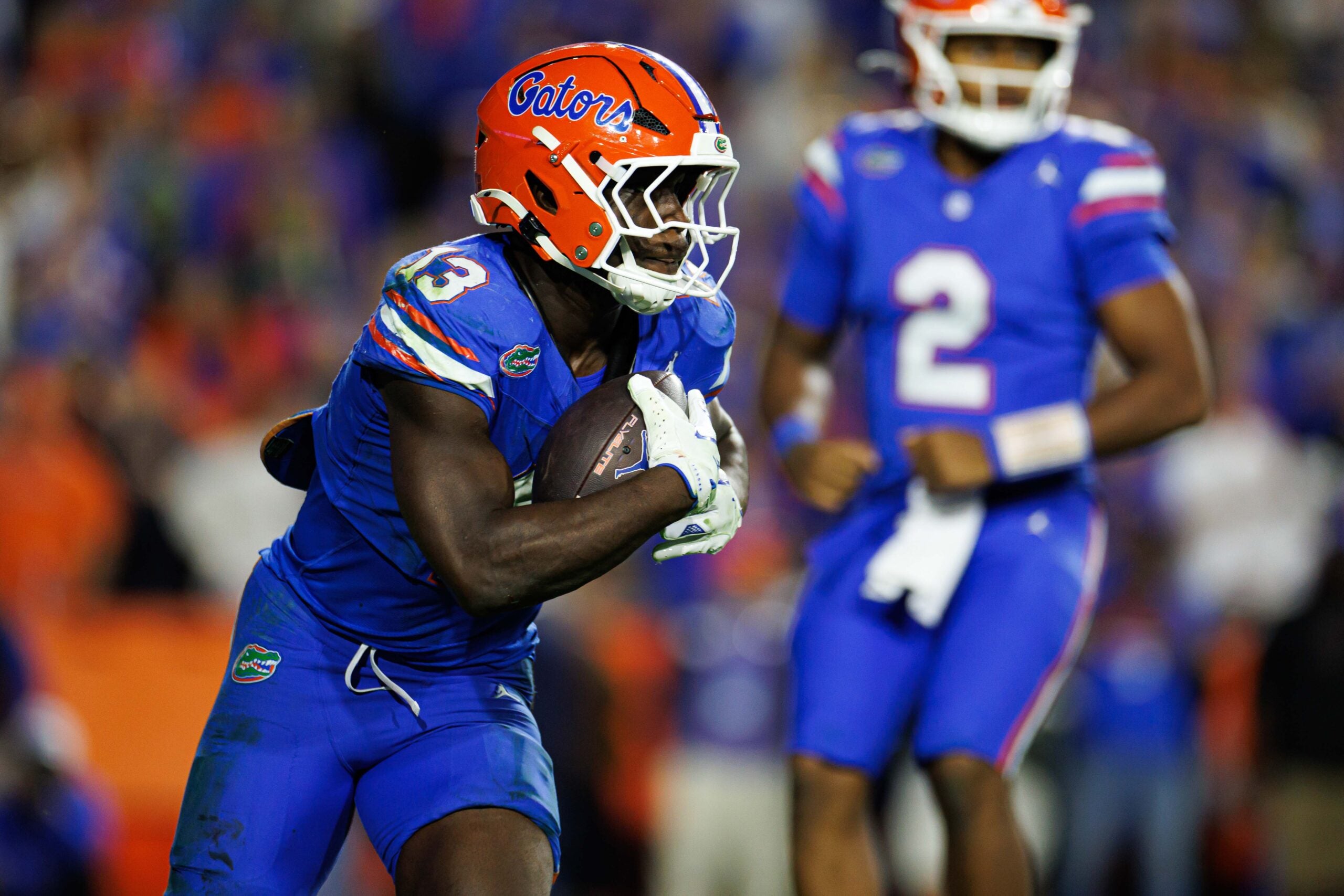 Nov 29, 2025; Gainesville, Florida, USA; Florida Gators running back Jadan Baugh (13) rushes with the ball against the Florida State Seminoles during the second half at Ben Hill Griffin Stadium.