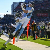 Nov 30, 2025; Nashville, Tennessee, USA; Jacksonville Jaguars safety Andrew Wingard (42) force Tennessee Titans tight end Gunnar Helm (84) out of bounds for an incomplete pass during the first half at Nissan Stadium.