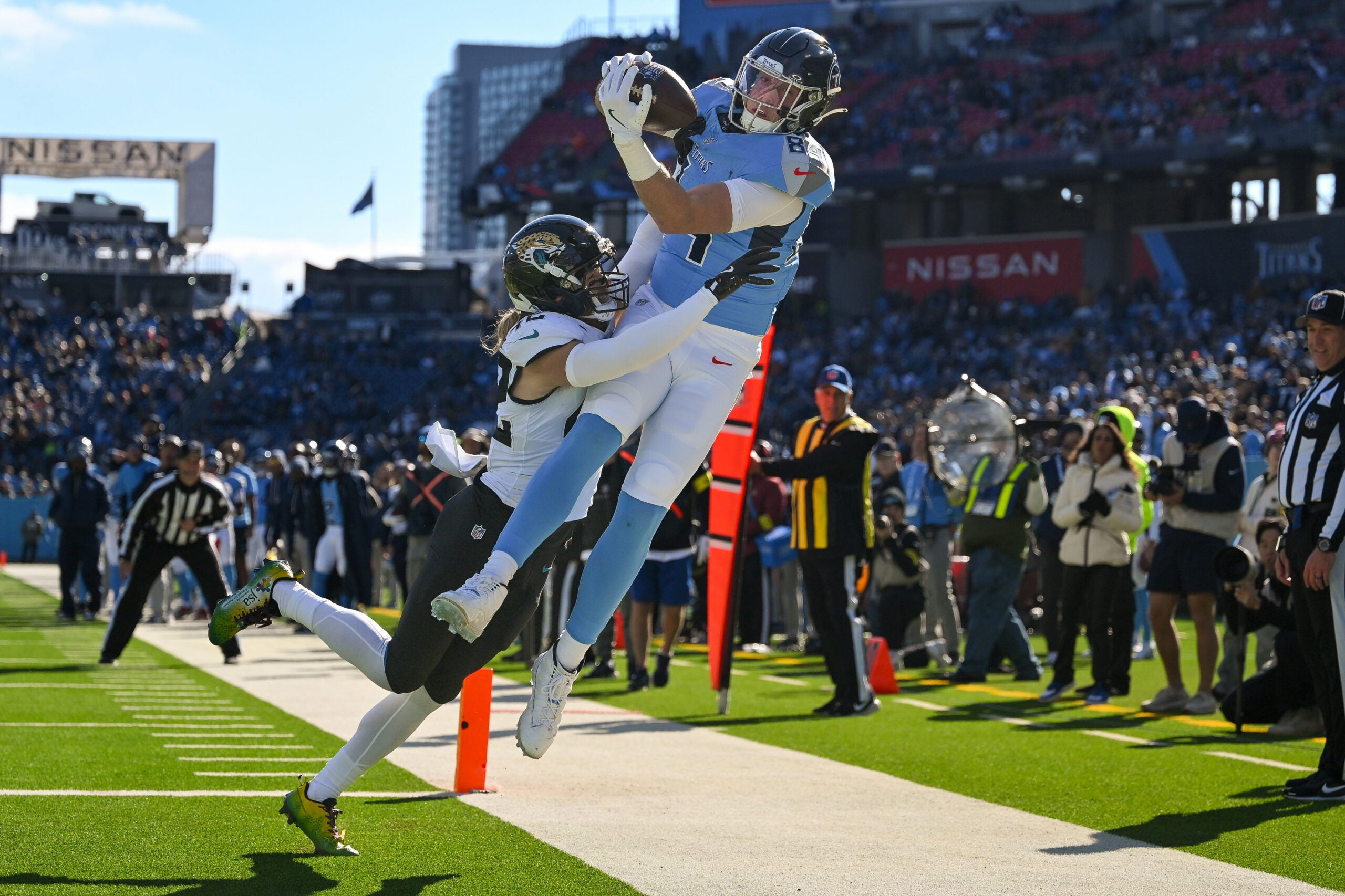 Nov 30, 2025; Nashville, Tennessee, USA; Jacksonville Jaguars safety Andrew Wingard (42) force Tennessee Titans tight end Gunnar Helm (84) out of bounds for an incomplete pass during the first half at Nissan Stadium.