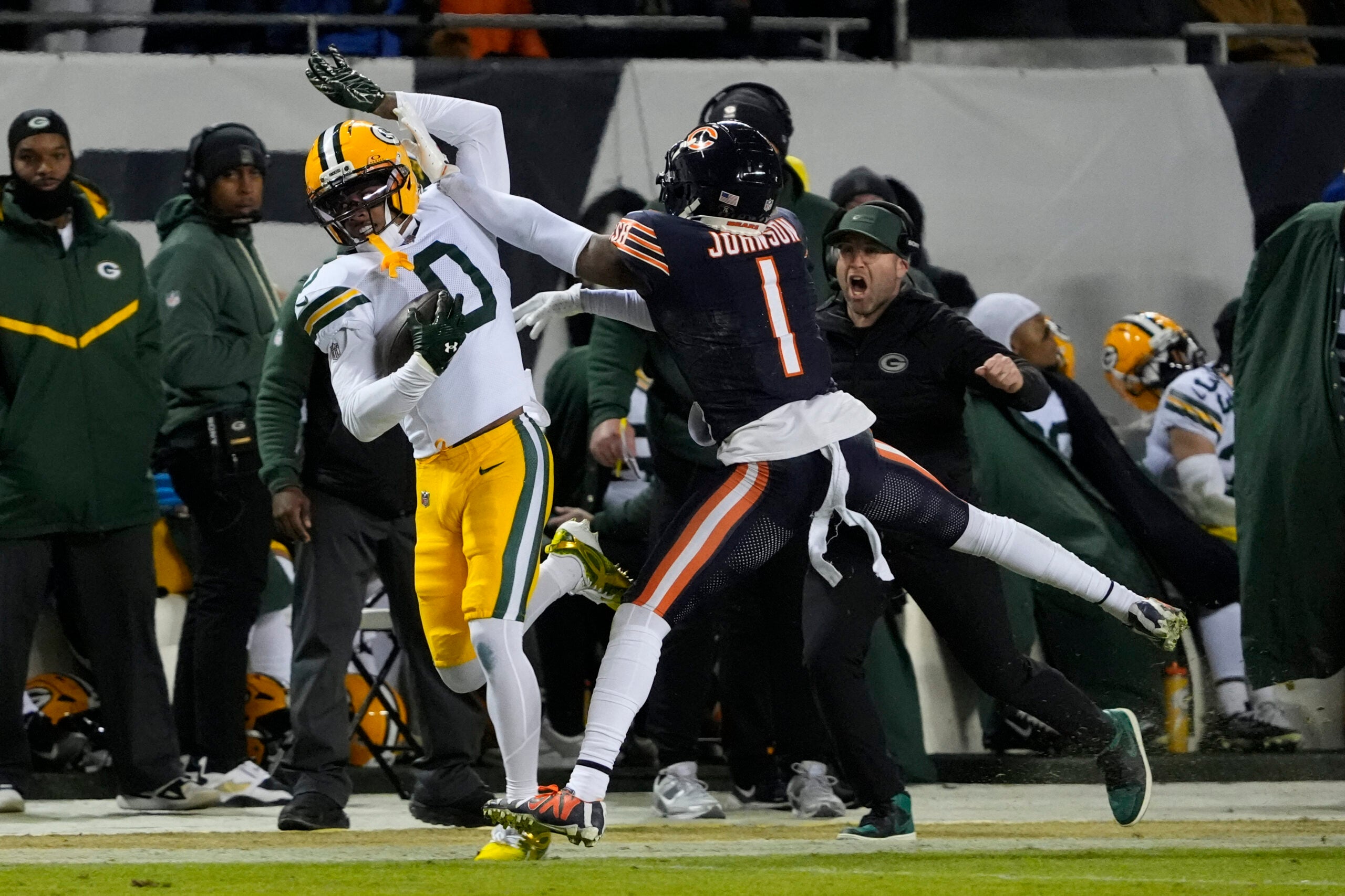 Jan 10, 2026; Chicago, IL, USA; Green Bay Packers wide receiver Matthew Golden (0) makes the reception as Chicago Bears cornerback Jaylon Johnson (1) defends during the first half of an NFC Wild Card Round game at Soldier Field.