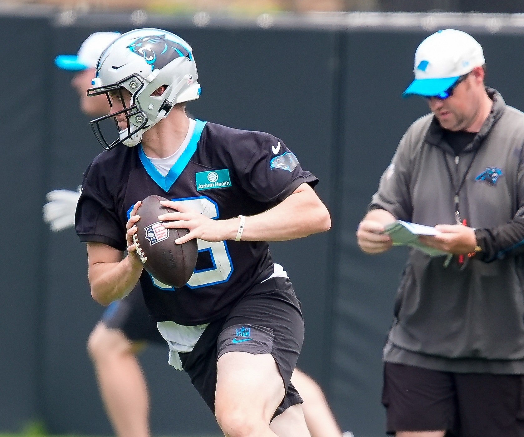 Jun 9, 2026; Charlotte, NC, USA; Carolina Panthers quarterback Haynes King (16) rolls out to pass during the first day of mini camp at Bank of America Stadium practice facility.