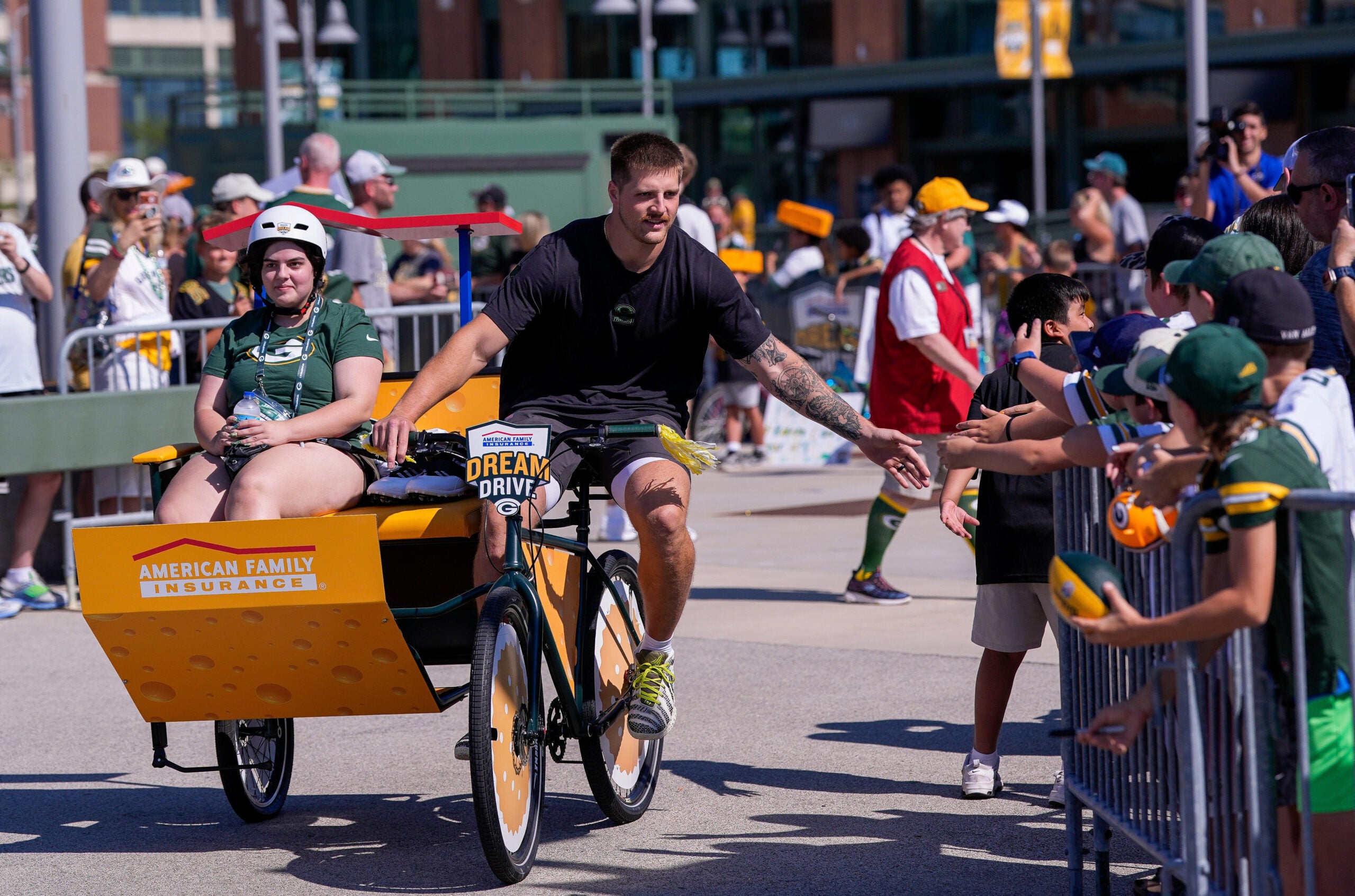 Green Bay Packers tight end Tucker Kraft rides a bicycle to practice during the first day of training camp on Wednesday, July 29, 2026, at Lambeau Field in Green Bay Wis.