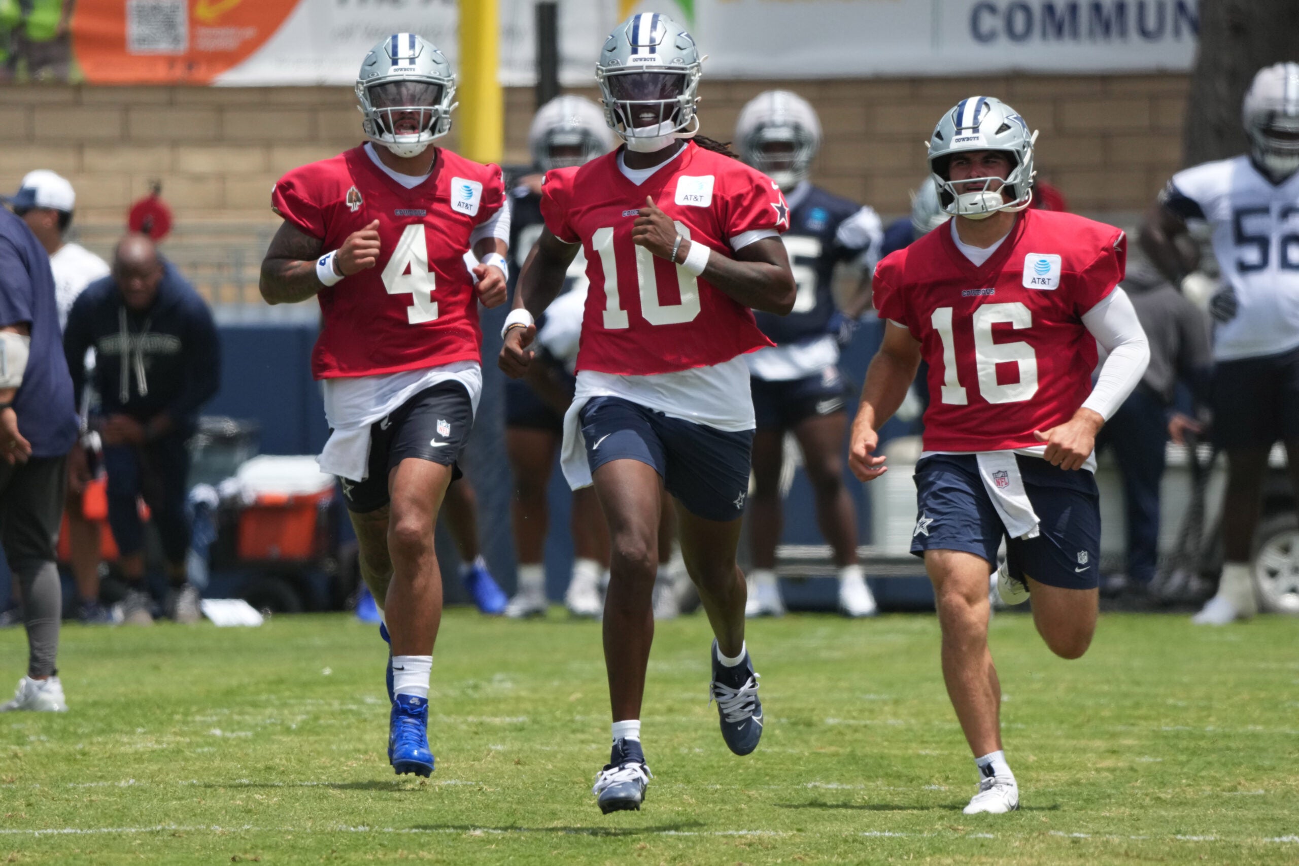 Jul 29, 2026; Oxnard, CA, USA; Dallas Cowboys quarterbacks Dak Prescott (4), Joe Milton (10) and Sam Howell (16) run at training camp at River Ridge Playing Fields.