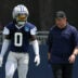 Jul 29, 2026; Oxnard, CA, USA; Dallas Cowboys linebacker DeMarvion Overshown (0) talks with inside linebackers coach Scott Symons at training camp at River Ridge Playing Fields.