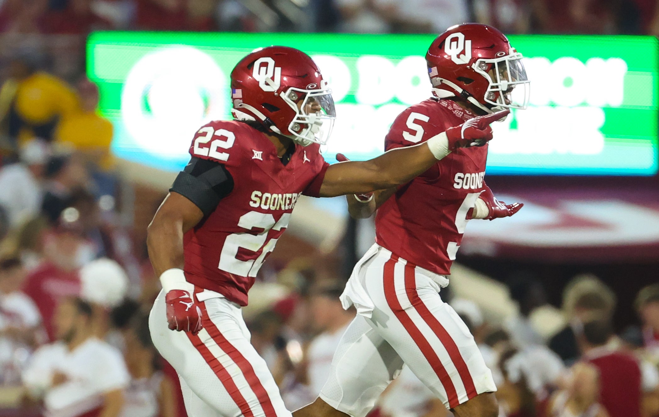 Sep 9, 2023; Norman, Oklahoma, USA; Oklahoma Sooners defensive back Peyton Bowen (22) celebrates with Oklahoma Sooners defensive back Woodi Washington (5)during the fourth quarter against the Southern Methodist Mustangs at Gaylord Family-Oklahoma Memorial Stadium.