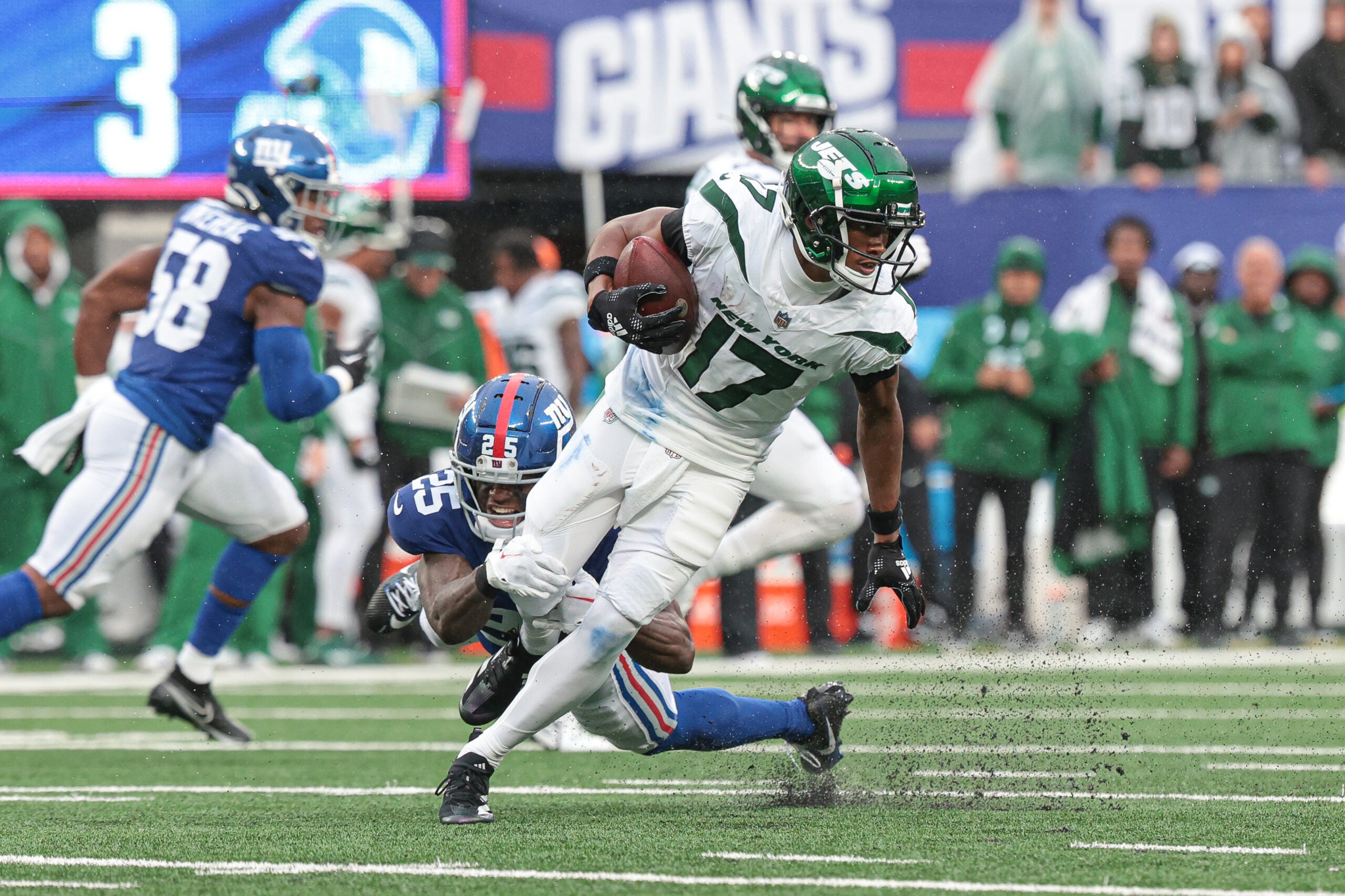 Oct 29, 2023; East Rutherford, New Jersey, USA; New York Jets wide receiver Garrett Wilson (17) breaks a tackle by New York Giants cornerback Deonte Banks (25) during the first half at MetLife Stadium.