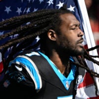 Nov 24, 2024; Charlotte, North Carolina, USA; Carolina Panthers linebacker Jadeveon Clowney (7) runs on to the field with the american flag before the game at Bank of America Stadium.