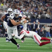 Nov 28, 2024; Arlington, Texas, USA; Dallas Cowboys tight end Luke Schoonmaker (86) catches a pass as New York Giants cornerback Cor'Dale Flott (28) defends during the first half at AT&T Stadium.