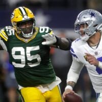 Green Bay Packers defensive tackle Devonte Wyatt (95) rushes Dallas Cowboys quarterback Dak Prescott (4) during the fourth quarter of their wild card playoff game Sunday, January 14, 2024 at AT&T Stadium in Arlington, Texas.