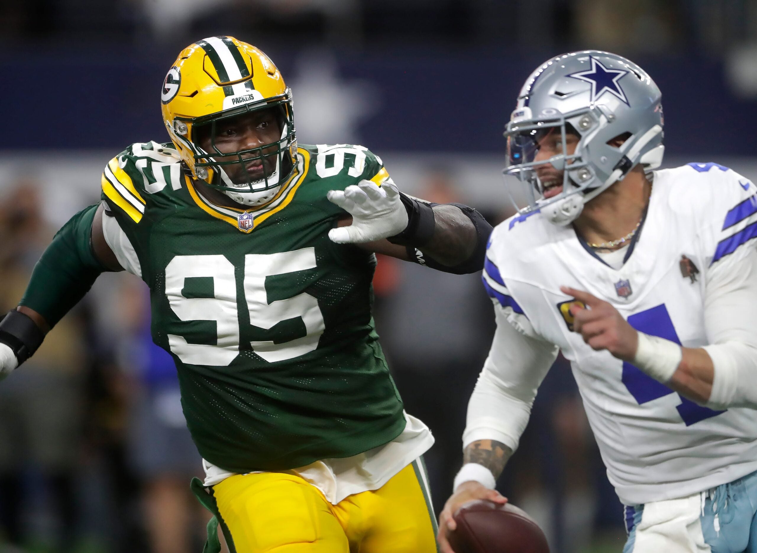 Green Bay Packers defensive tackle Devonte Wyatt (95) rushes Dallas Cowboys quarterback Dak Prescott (4) during the fourth quarter of their wild card playoff game Sunday, January 14, 2024 at AT&T Stadium in Arlington, Texas.