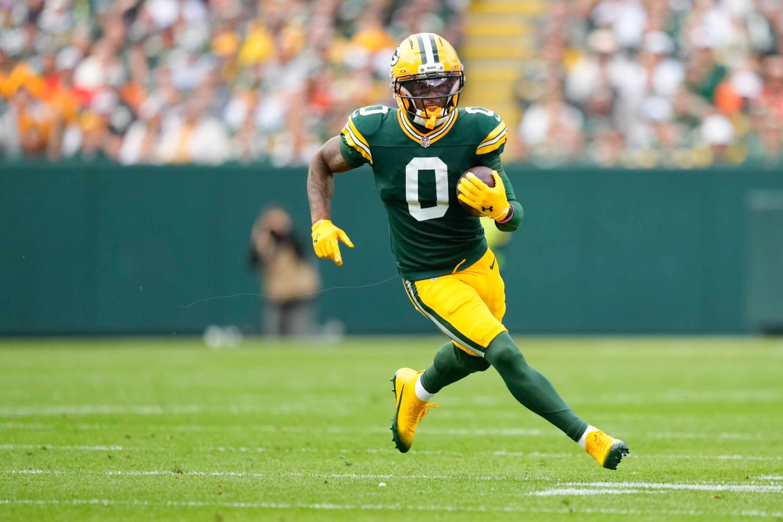 Oct 12, 2025; Green Bay, Wisconsin, USA; Green Bay Packers wide receiver Matthew Golden (0) runs with the ball during the first quarter against the Cincinnati Bengals at Lambeau Field.