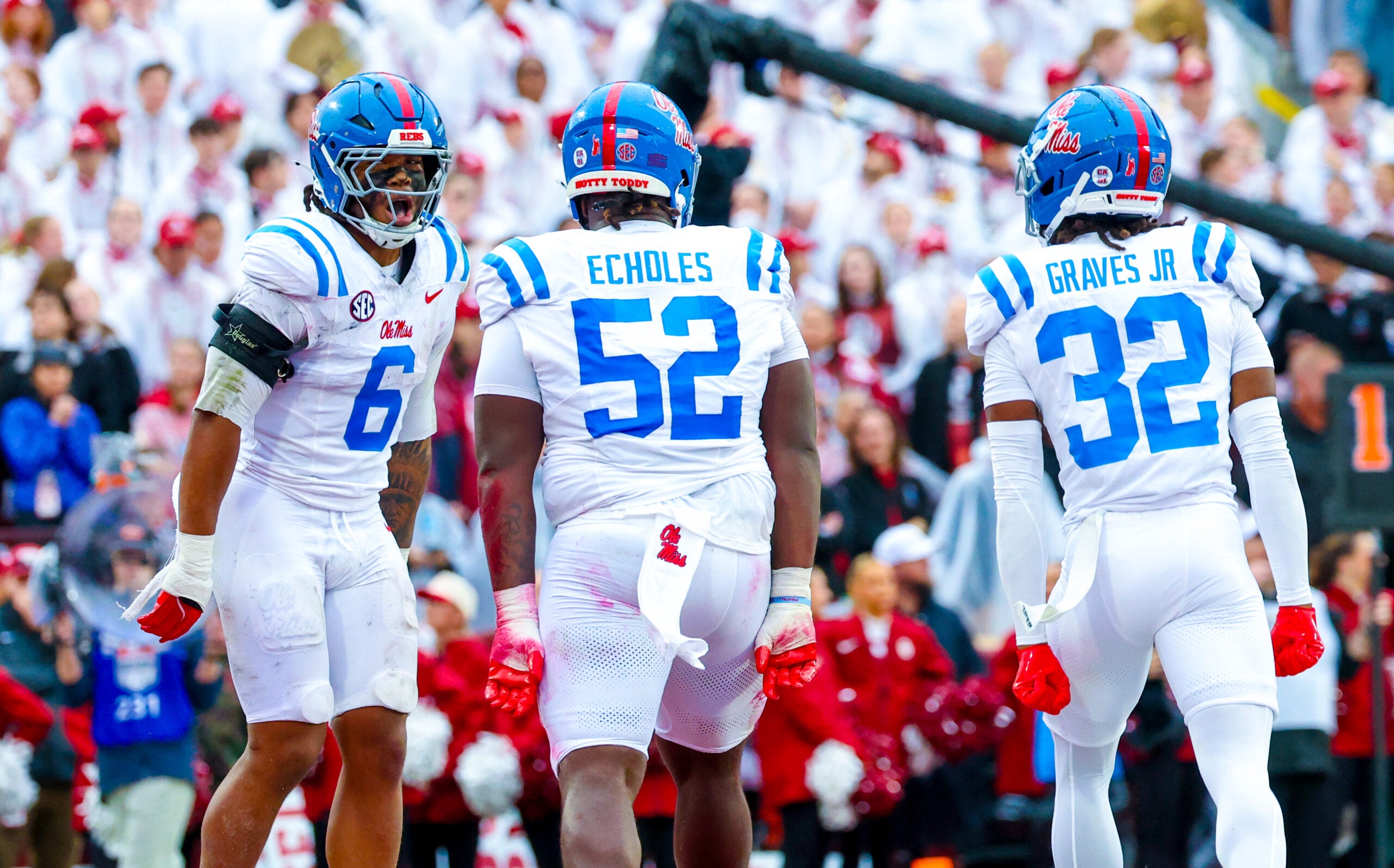 Oct 25, 2025; Norman, Oklahoma, USA; Ole Miss Rebels linebacker TJ Dottery (6) and Ole Miss Rebels defensive tackle Will Echoles (52) and Ole Miss Rebels cornerback Chris Graves Jr. (32) celebrate after recording a safety during the first half against the Oklahoma Sooners at Gaylord Family-Oklahoma Memorial Stadium.