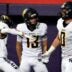 Iowa City Regina’s Tate Wallace (0) celebrates with teammates after scoring a touchdown Nov. 20, 2025 during the Class 1A state football championship against the West Lyon Wildcats at the UNI-Dome in Cedar Falls, Iowa.