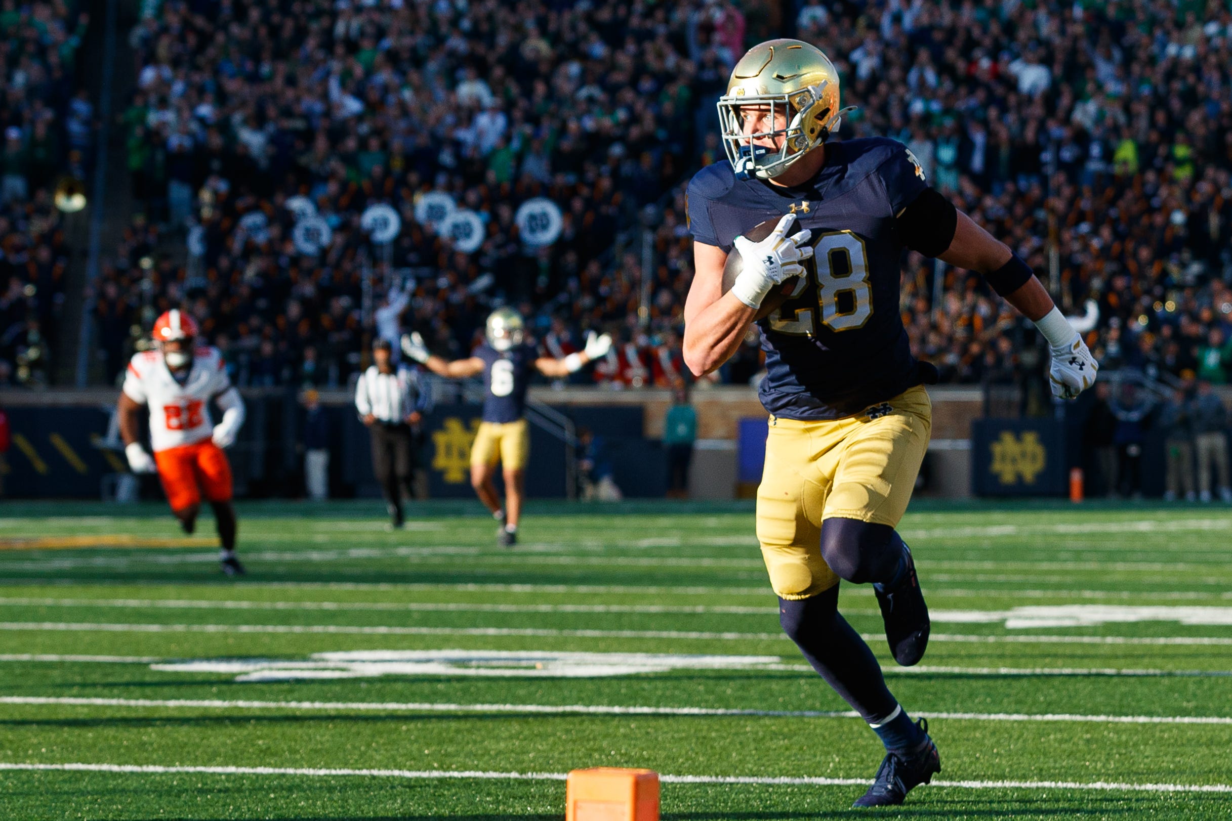 Notre Dame safety Luke Talich (28) runs a blocked punt into the end zone for a touchdown in the first half of a NCAA football game against Syracuse at Notre Dame Stadium on Saturday, Nov. 22, 2025, in South Bend.