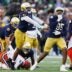 Notre Dame defensive lineman Bryce Young (95) celebrates sacking Syracuse quarterback Joseph Filardi, bottom left, in the first half of a NCAA football game against Syracuse at Notre Dame Stadium on Saturday, Nov. 22, 2025, in South Bend.