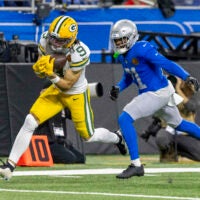 Nov 27, 2025; Detroit, Michigan, USA; Green Bay Packers wide receiver Christian Watson (9) catches a pass against Detroit Lions cornerback Amik Robertson (21) during the third quarter at Ford Field.
