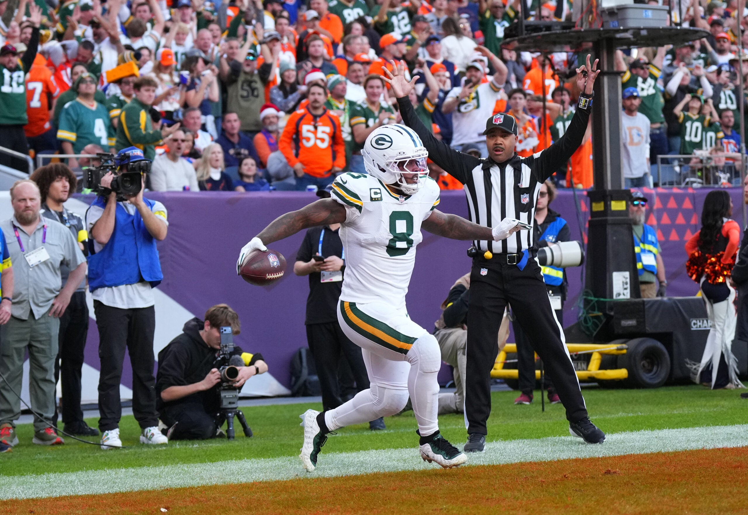 Dec 14, 2025; Denver, Colorado, USA; Green Bay Packers running back Josh Jacobs (8) reacts after a touchdown during the second quarter against the Denver Broncos at Empower Field at Mile High.