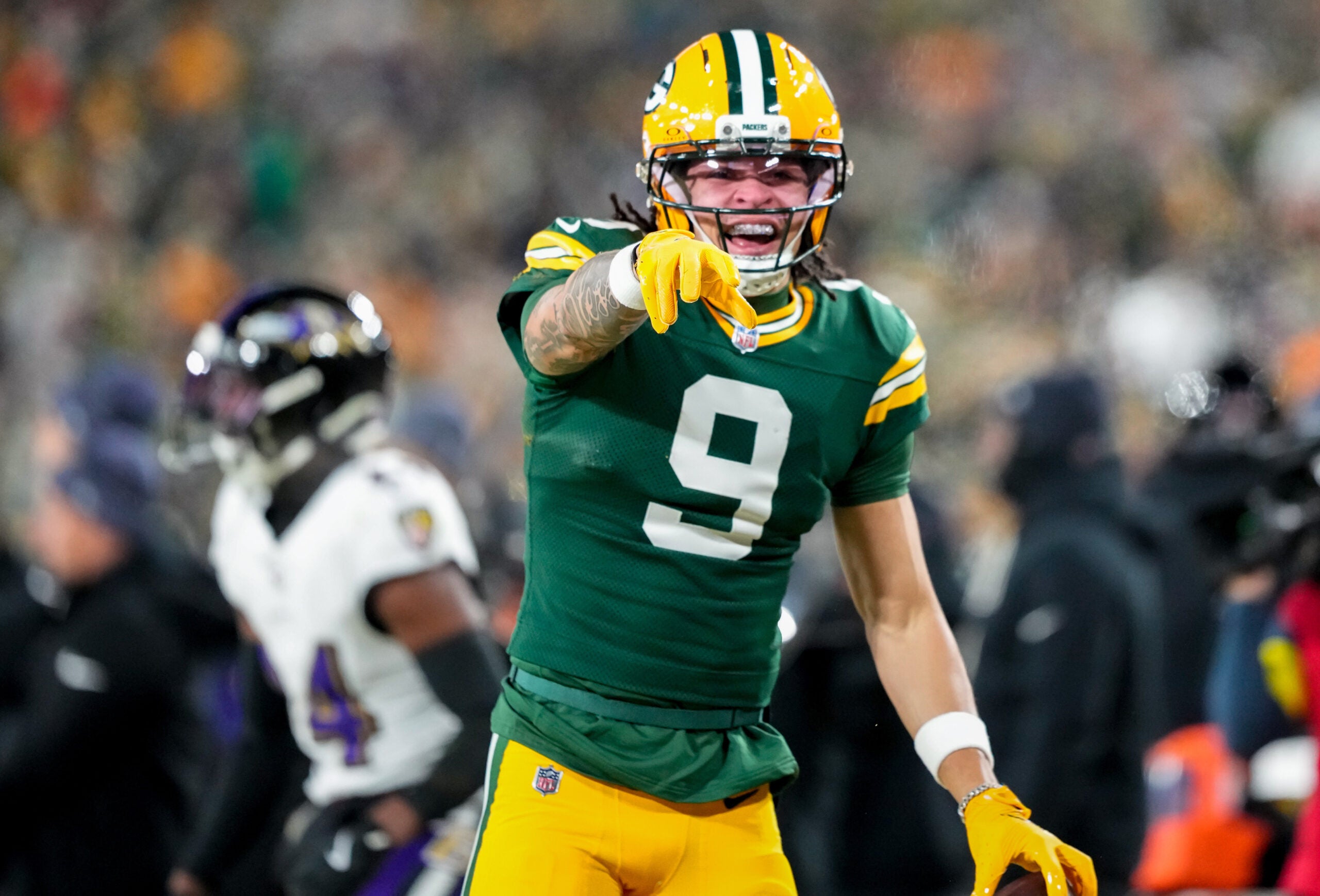 Dec 27, 2025; Green Bay, Wisconsin, USA; Green Bay Packers wide receiver Christian Watson (9) celebrates after catching a pass during the third quarter against the Baltimore Ravens at Lambeau Field.