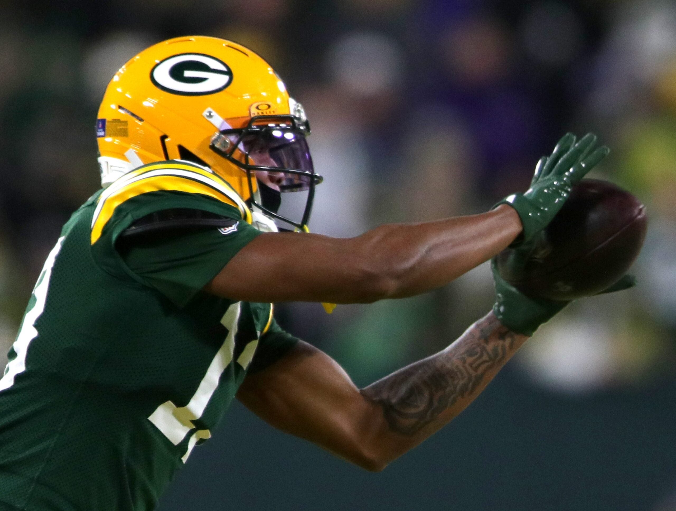 Green Bay Packers wide receiver Dontayvion Wicks (13) catches a pass against the Baltimore Ravens on Saturday, December 27, 2025, at Lambeau Field in Green Bay, Wis. The Ravens defeated the Packers 41-24.