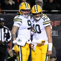Jan 10, 2026; Chicago, IL, USA; Green Bay Packers wide receiver Christian Watson (9) and quarterback Jordan Love (10) react after hooking up on a touchdown pass and catch against the Chicago Bears during the first half of an NFC Wild Card Round game at Soldier Field.