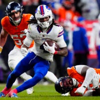 Jan 17, 2026; Denver, CO, USA; Buffalo Bills running back James Cook III (4) runs against Denver Broncos linebacker Jonah Elliss (52) and defensive end Eyioma Uwazurike (96) during the fourth quarter of an AFC Divisional Round playoff game at Empower Field at Mile High.