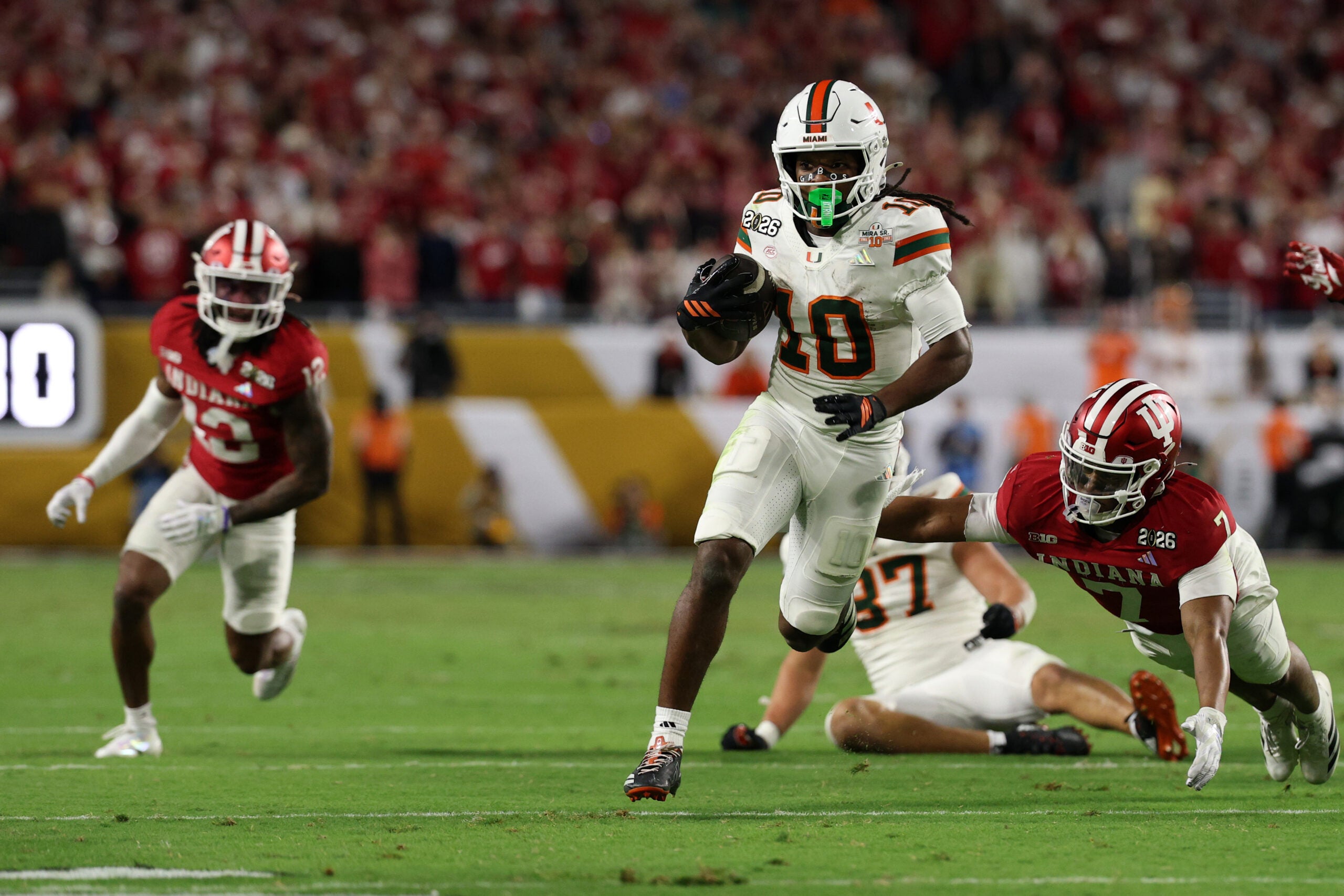Jan 19, 2026; Miami Gardens, FL, USA; Miami Hurricanes wide receiver Malachi Toney (10) rushes the ball for a touchdown against the Indiana Hoosiers in the second half during the College Football Playoff National Championship game at Hard Rock Stadium.