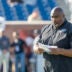 Jan 29, 2026; Mobile, AL, USA; National Team head coach Clint Hurtt of the Philadelphia Eagles checks his notes during National Senior Bowl practice at Hancock Whitney Stadium.