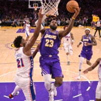 Feb 5, 2026; Los Angeles, California, USA; Los Angeles Lakers forward LeBron James (23) drives past Philadelphia 76ers center Joel Embiid (21) in the second half at Crypto.com Arena.