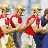 Notre Dame quarterbacks Blake Hebert, left, Noah Grubbs, center, and CJ Carr wait for a snap during a football practice at Irish Athletic Center on Friday, March 20, 2026, in South Bend.