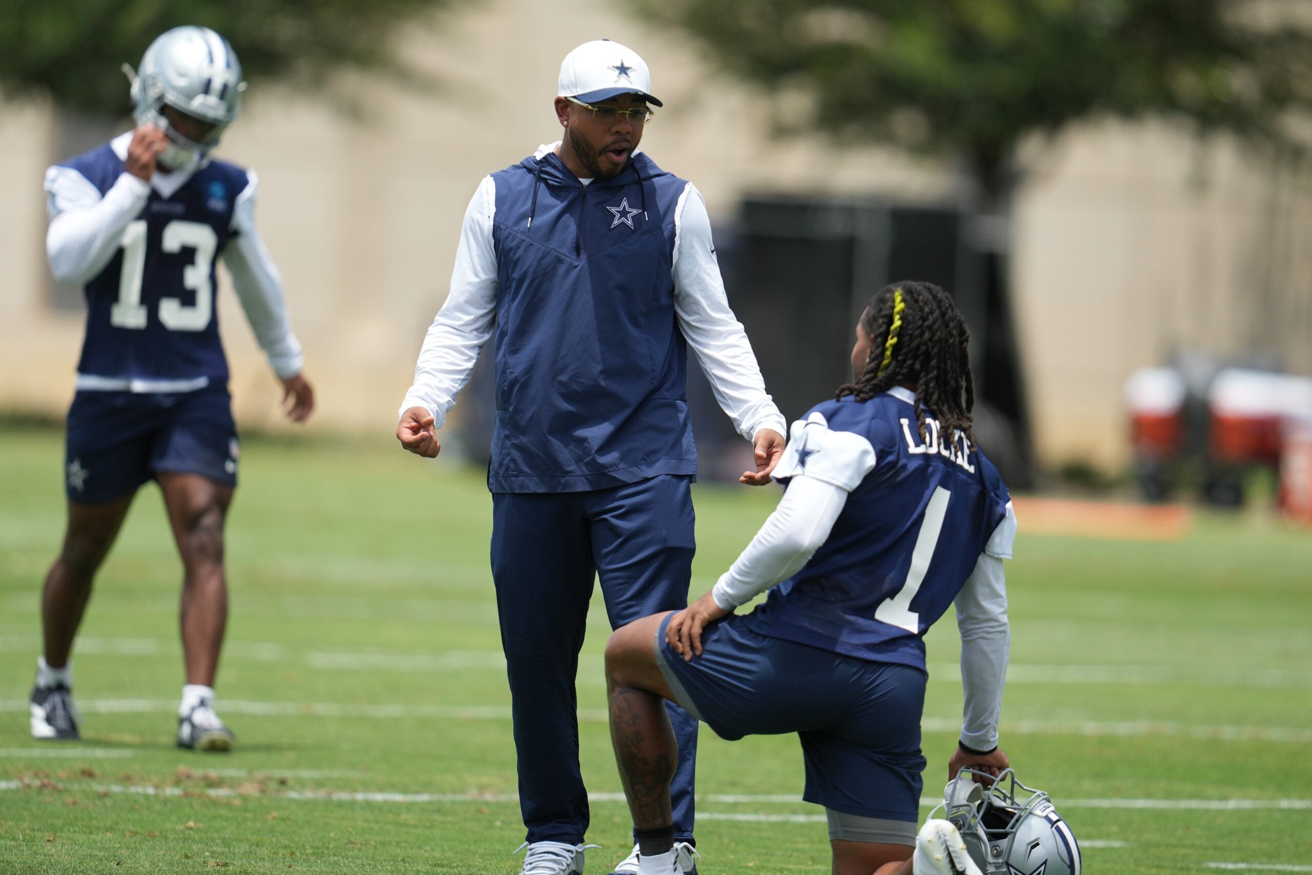 Jun 16, 2026; Dallas, TX, USA; Dallas Cowboys defensive coordinator Christian Parker speaks with wide receiver PJ Locke (1) during practice at the Ford Center at the Star Training Facility in Frisco, Texas.