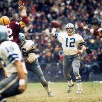 Nov 21, 1971; Washington, DC, USA; FILE PHOTO; Dallas Cowboys quarterback Roger Staubach (12) is pressured by Washington Redskins defensive end Jimmie Jones (82) at RFK Stadium.