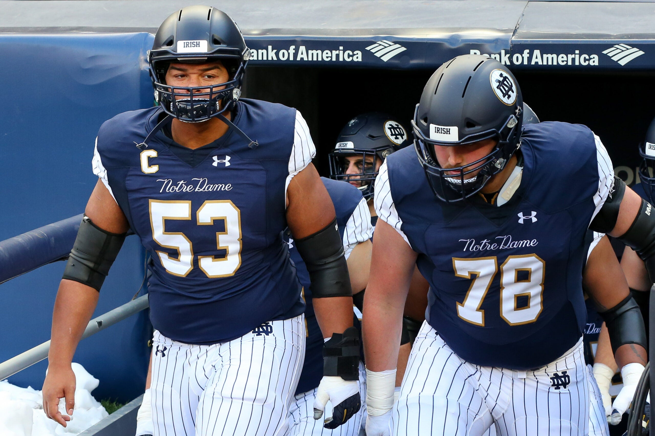 Nov 17, 2018; New York, NY, USA; Notre Dame Fighting Irish offensive lineman Sam Mustipher (53) and offensive lineman Tommy Kraemer (78) walk on the field prior to the game against the Syracuse Orange at Yankee Stadium.