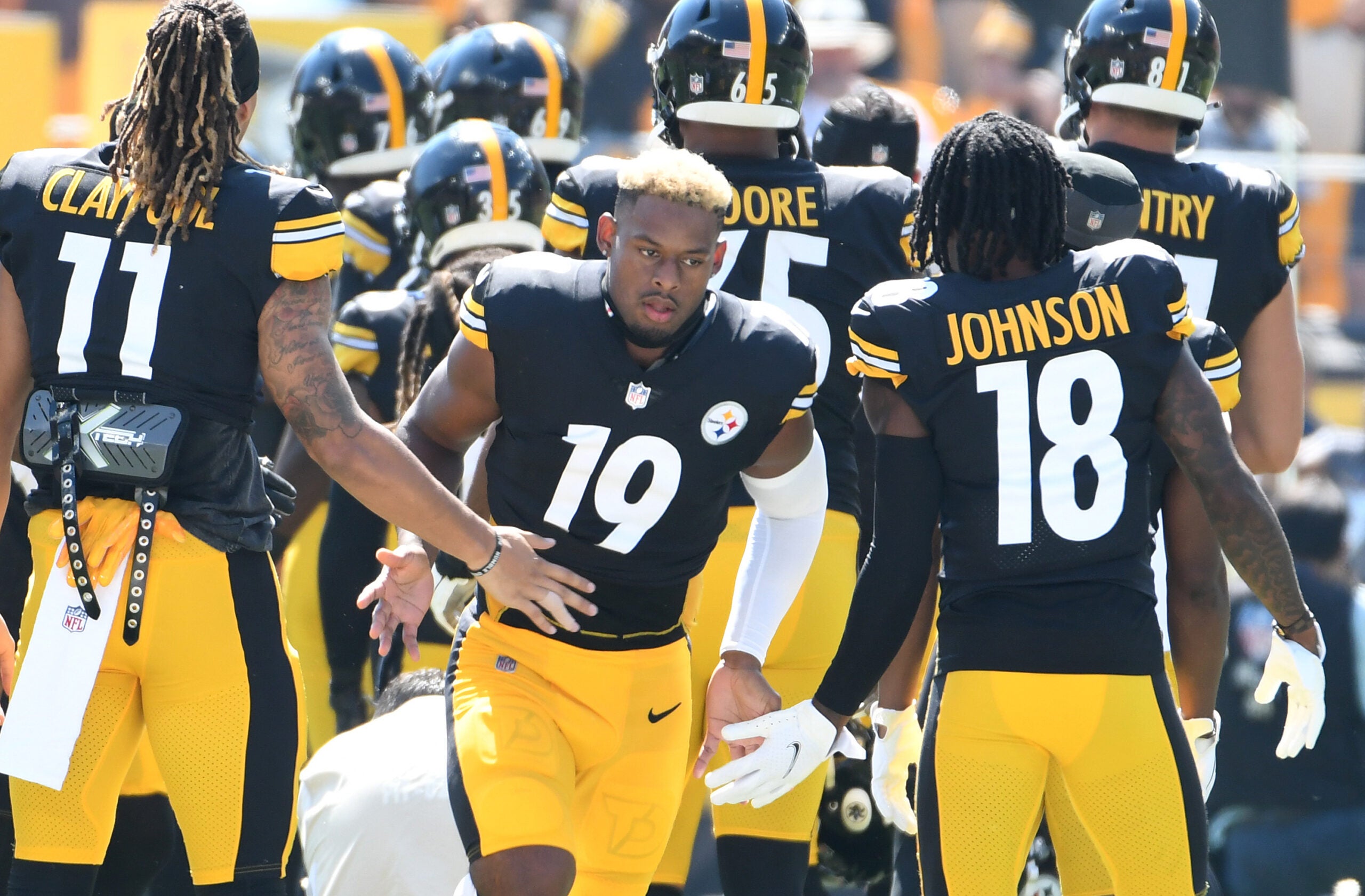 Sep 19, 2021; Pittsburgh, Pennsylvania, USA; Pittsburgh Steelers wide receiver JuJu Smith-Schuster is greeted by his teammates as they take the field to play the Las Vegas Raiders at Heinz Field. The Raiders won the game 26-17.