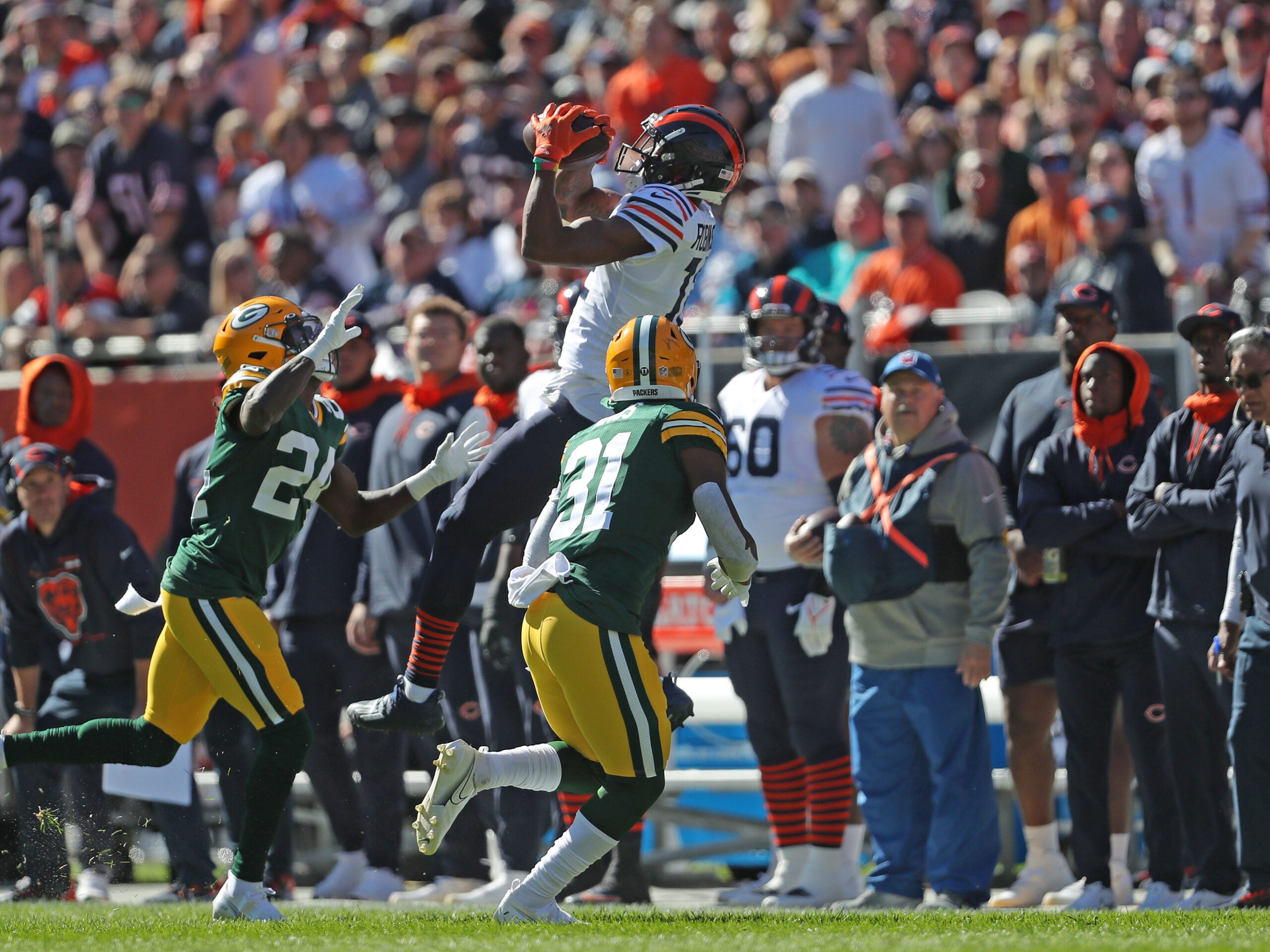 Oct 17, 2021; Chicago, Illinois, USA; Chicago Bears wide receiver Allen Robinson (12) catches a pass over Green Bay Packers safety Adrian Amos (31) and cornerback Isaac Yiadom (24) during the first half at Soldier Field.