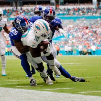 Oct 8, 2023; Miami Gardens, Florida, USA; Miami Dolphins wide receiver Tyreek Hill (10) runs with the football against the New York Giants during the first quarter at Hard Rock Stadium.