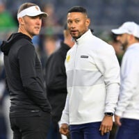 Oct 14, 2023; South Bend, Indiana, USA; USC Trojans head coach Lincoln Riley and Notre Dame Fighting Irish head coach Marcus Freeman chat before the game at Notre Dame Stadium.