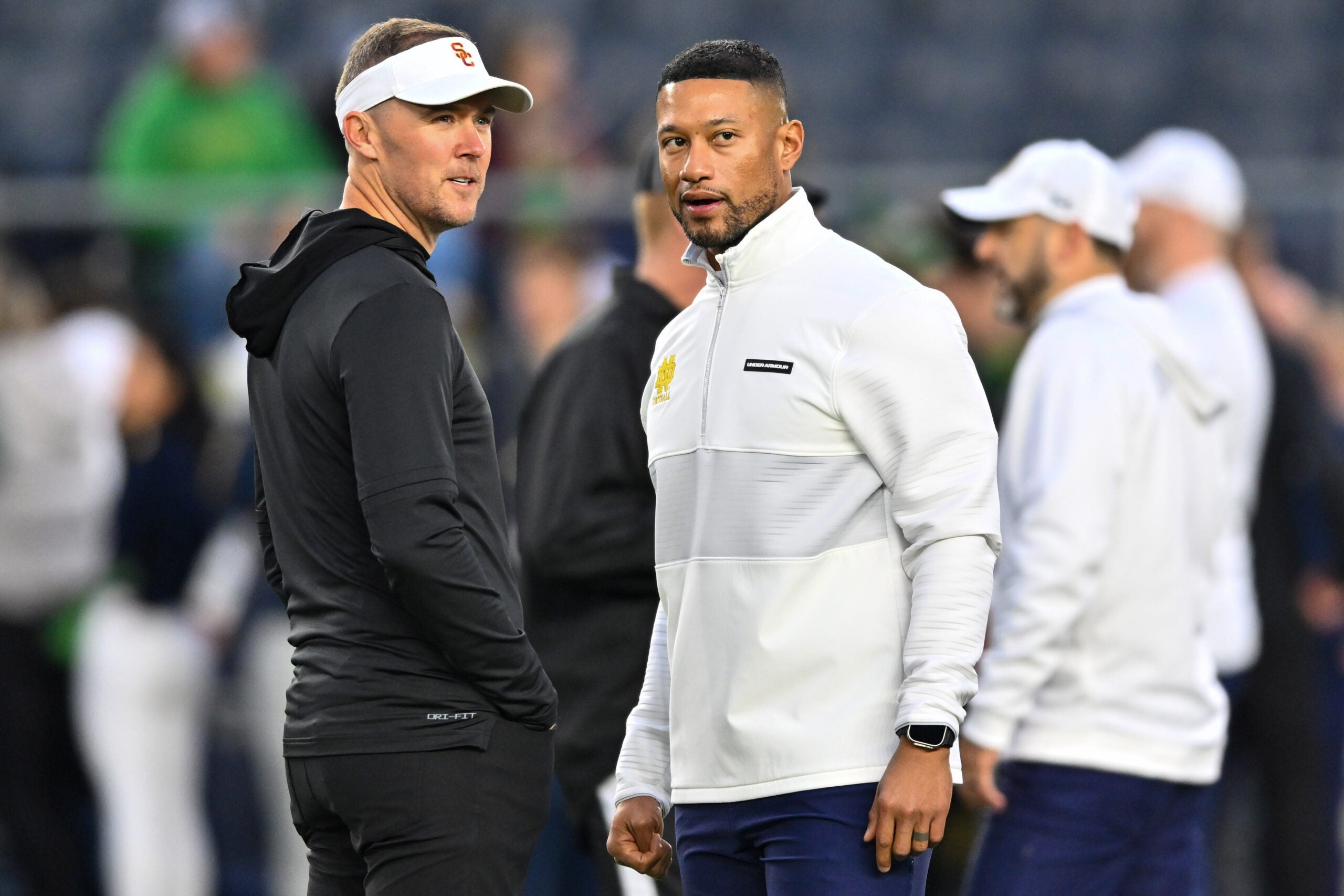 Oct 14, 2023; South Bend, Indiana, USA; USC Trojans head coach Lincoln Riley and Notre Dame Fighting Irish head coach Marcus Freeman chat before the game at Notre Dame Stadium.