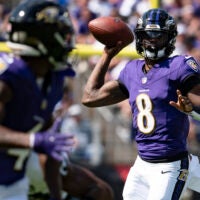 Sep 15, 2024; Baltimore, Maryland, USA; Baltimore Ravens quarterback Lamar Jackson (8) throws looks to throw wide receiver Zay Flowers (4) during the first half against the Las Vegas Raiders at M&T Bank Stadium.
